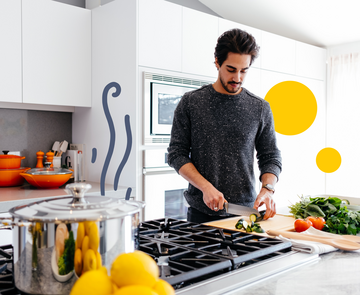 Tatenbank Kochen - Mann kochend in einer Küche, darin gelbe Sphären