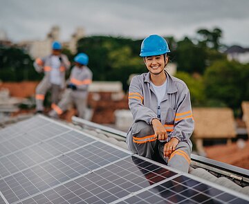 woman working on installation and maintenance of solar panels