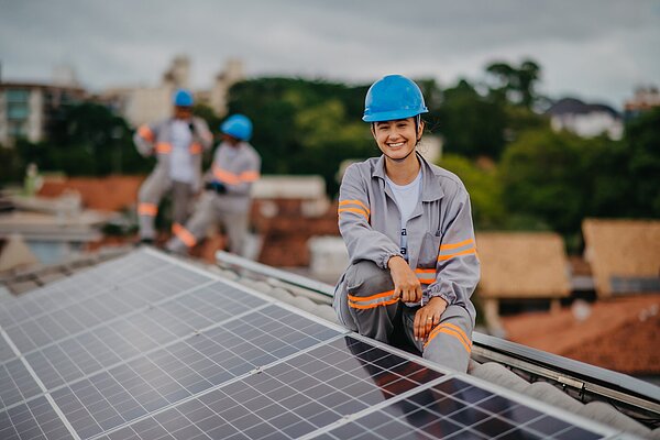 woman working on installation and maintenance of solar panels
